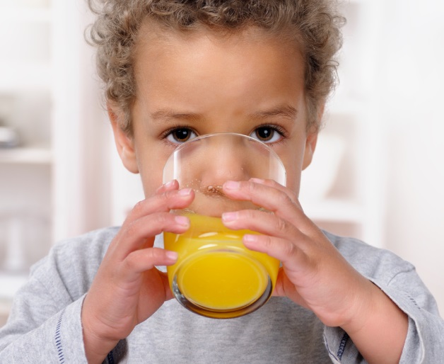 Child drinking orange juice