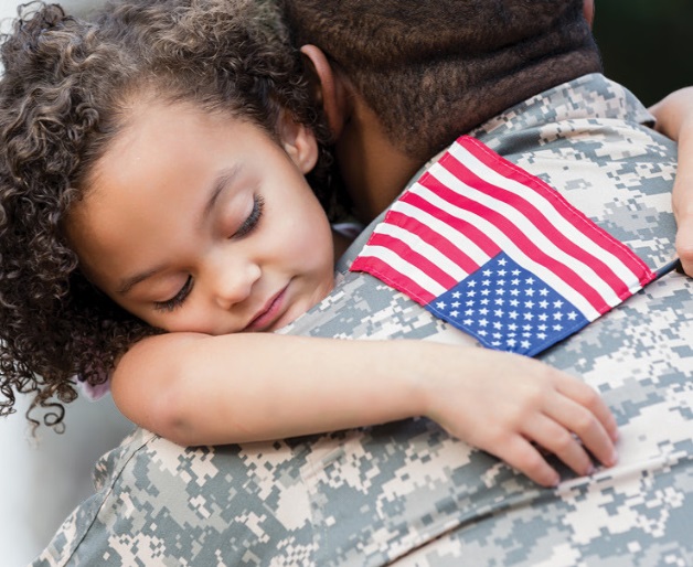 Soldier hugging child