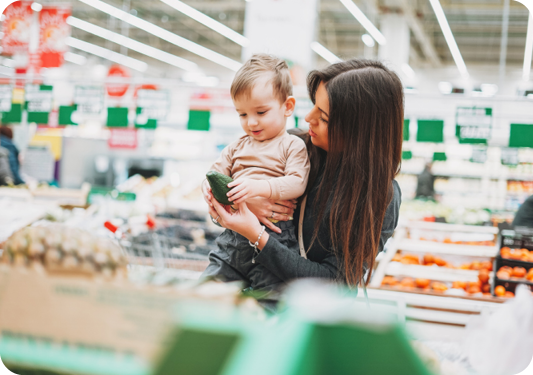 Mother holding child in a grocery store