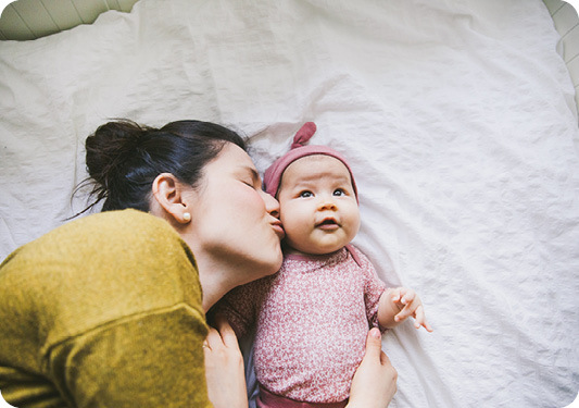 Mom kissing baby