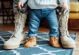 Toddler between boots