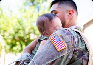 Military father holding baby