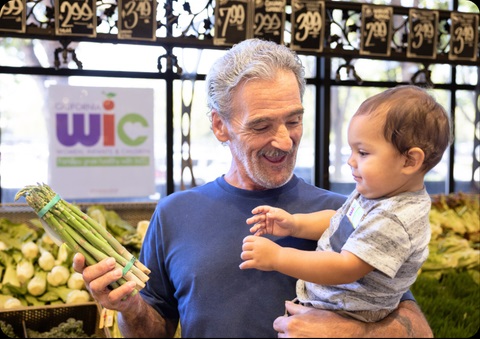 Grandfather shopping with child